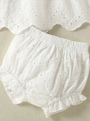 White embroidered lace baby top and shorts set with ruffled trim and eyelet details.