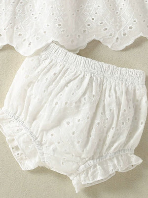 White embroidered lace baby top and shorts set with ruffled trim and eyelet details.