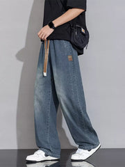 Relaxed vintage wash wide-leg jeans in Gray Blue with drawstring waist and patch detail.