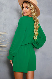 Mid Green tie-front blouson sleeve playsuit with cinched waist and smocked cuffs.