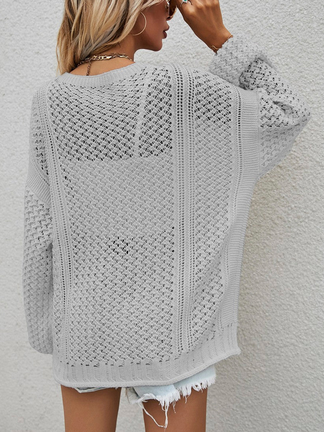 Open-knit acrylic cardigan in light grey with balloon sleeves and a relaxed fit.