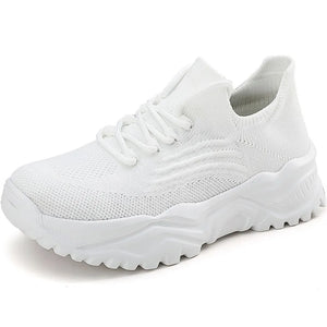 White knit sneakers with textured pattern and chunky sole.