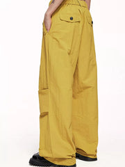Ginger yellow cargo joggers with drawstring waist and button flap back pockets.