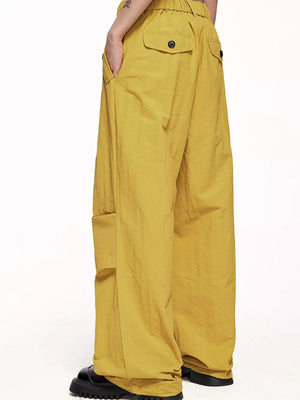 Ginger yellow cargo joggers with drawstring waist and button flap back pockets.