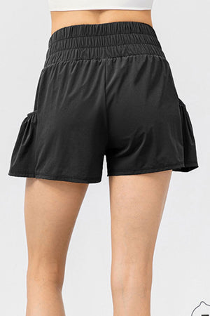 Black active shorts with gathered waistline and ruffled side pockets.