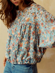 Cropped denim trucker jacket with allover floral print and elasticized hem.