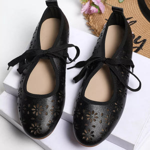 Black floral cutout slip-on flats with tie detail