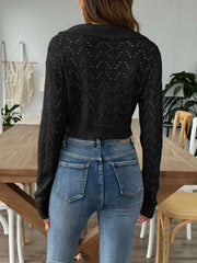 Black cropped pointelle knit polo top with a collared neckline and long sleeves.