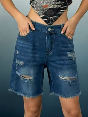 Dark blue denim shorts with distressed rips and frayed hem.