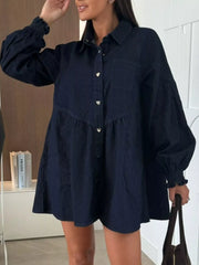 Dark blue denim mini dress with pockets, button front, heart buttons, and cinched cuffs.