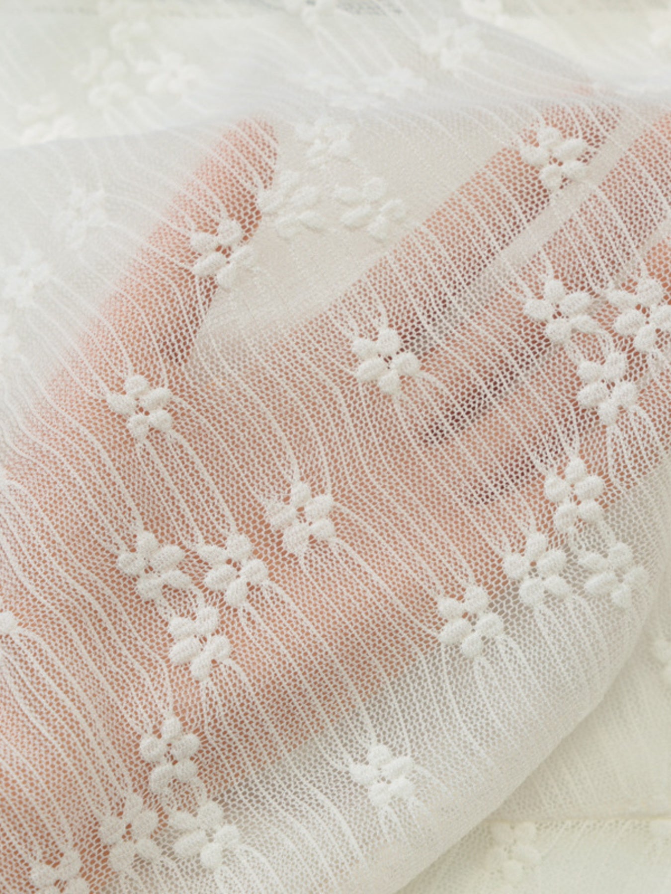 White lace mini dress fabric with floral embroidery and sheer texture