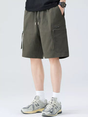 Men's military green cargo shorts with drawstring waist and zip pockets.