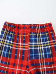 Baby shorts with red, blue, and yellow plaid pattern and elastic waistband.