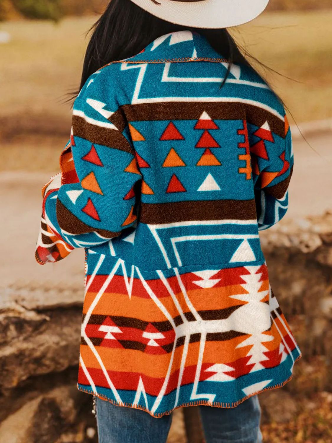 Southwestern print shawl collar jacket in peacock blue with geometric and triangle patterns.