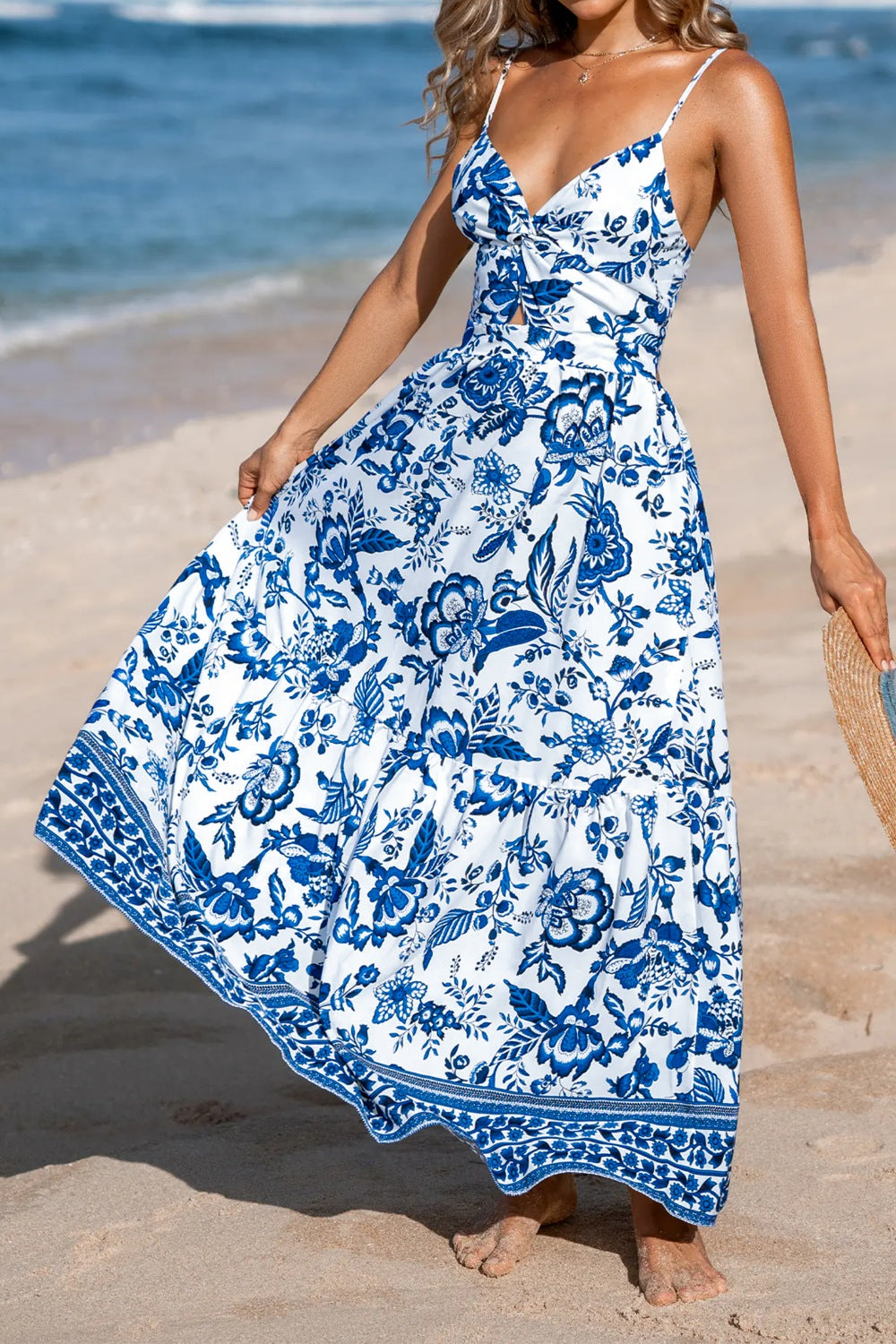 Maxi dress with blue Chinoiserie floral print, cutout detail, and tiered skirt.
