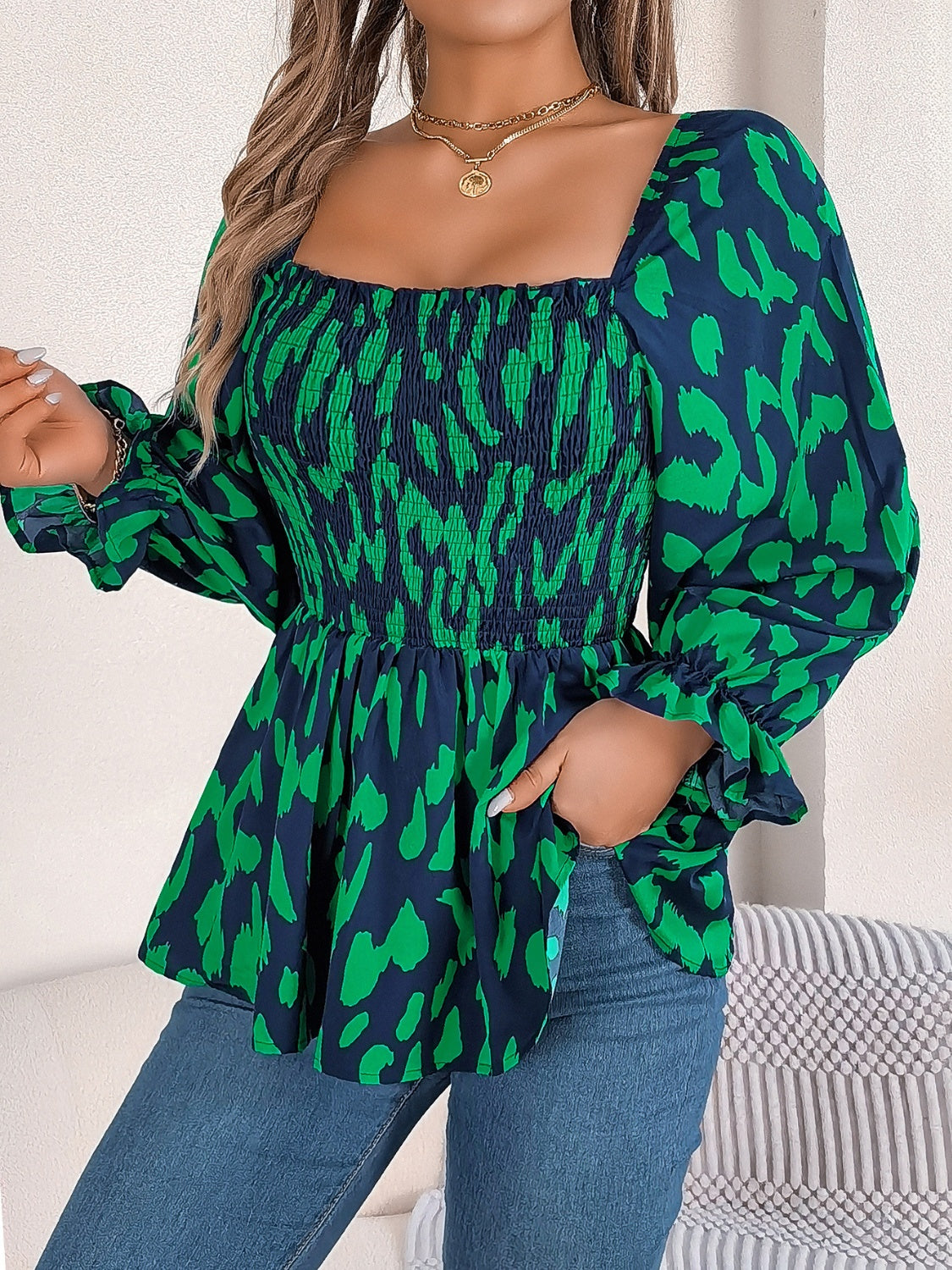 Smocked bodice square neck blouse in dark green and navy animal print with puff sleeves.