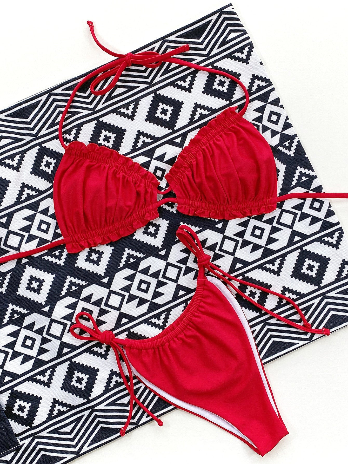 Red ruffle tie bikini set with white trim and string ties.