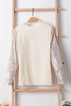 Ivory silk blend blouse with full sequin sleeves and crew neck.