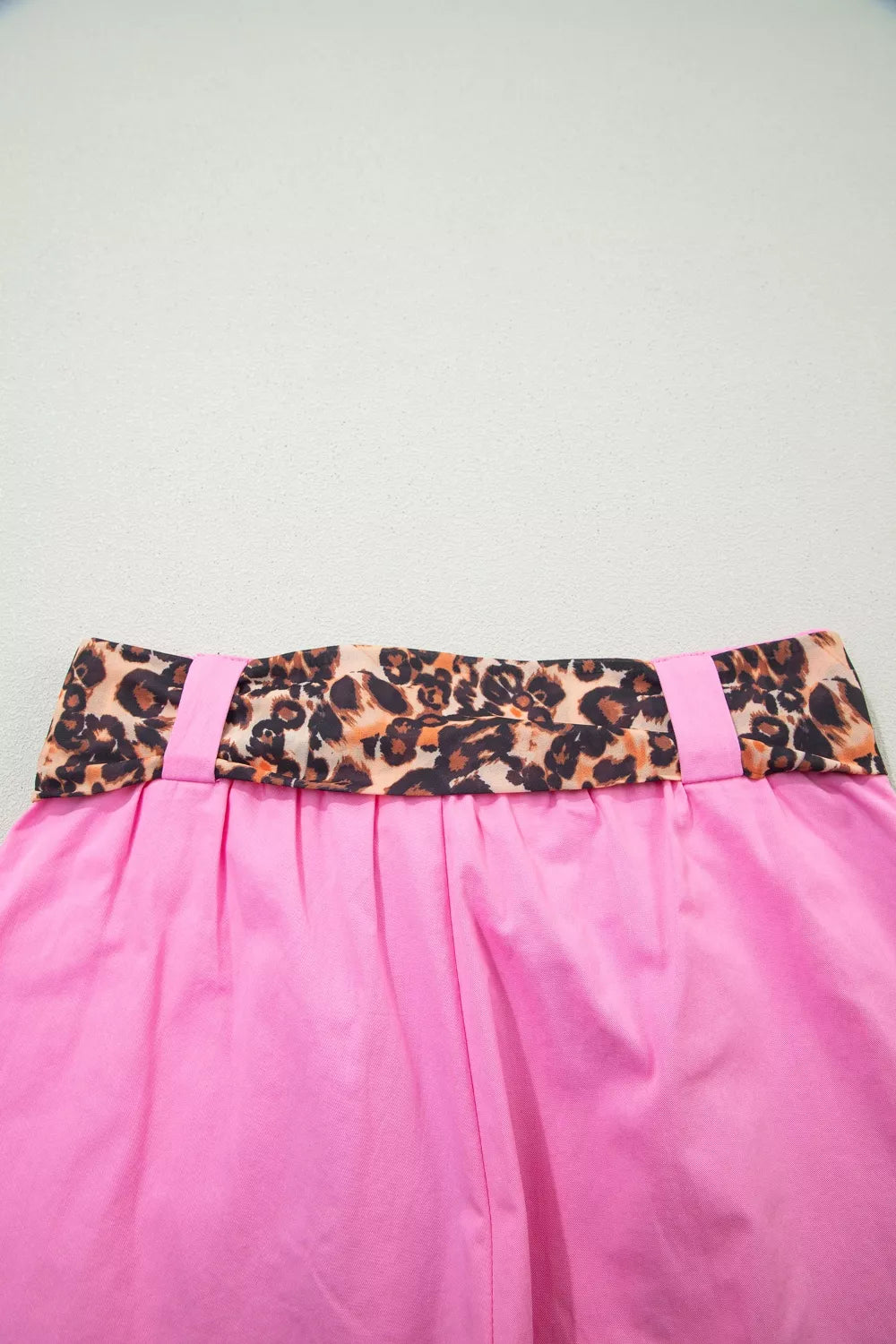 Pink chino shorts with high waist and leopard print belted detail.