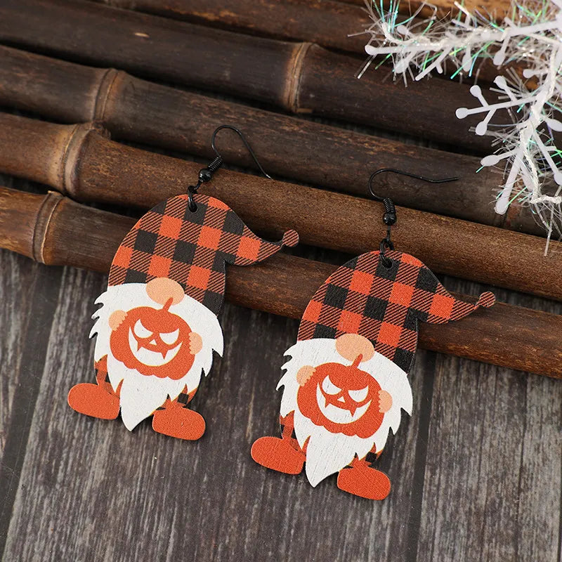 Gnome plaid pumpkin patch earrings with white beards and orange feet.