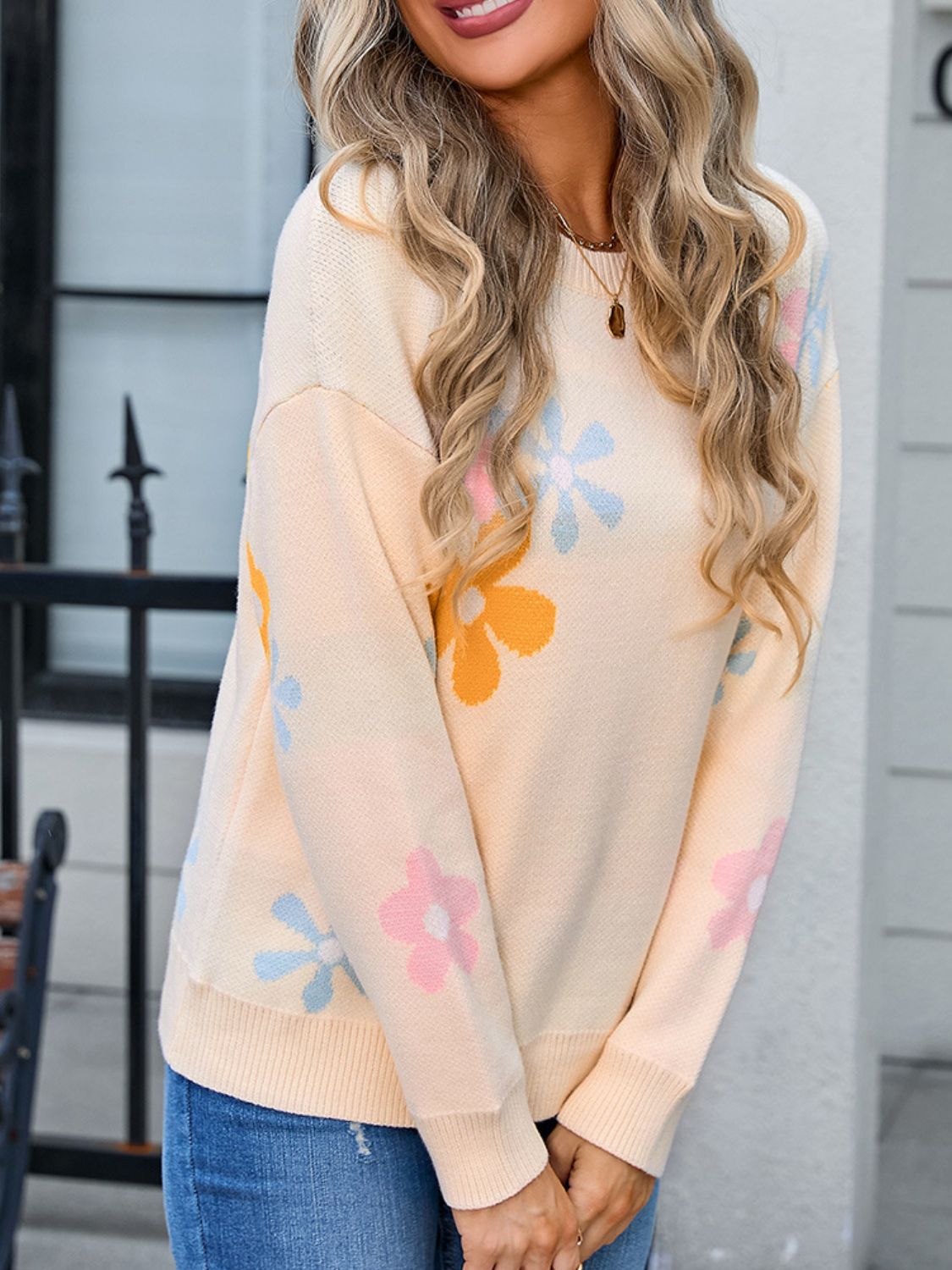 Apricot floral intarsia knit crewneck pullover sweater with pastel flowers.