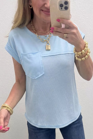 Light blue waffle knit t-shirt with a chest pocket and curved hem