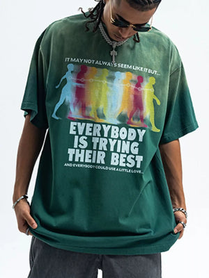 Men's green acid wash graphic t-shirt with colorful figures and text print.