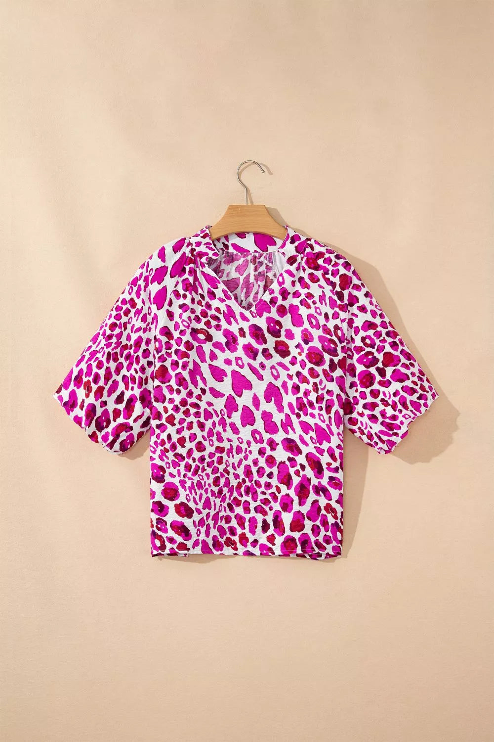 Vibrant leopard print V-neck blouse with short sleeves and a relaxed fit.
