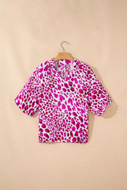 Vibrant leopard print V-neck blouse with short sleeves and a relaxed fit.