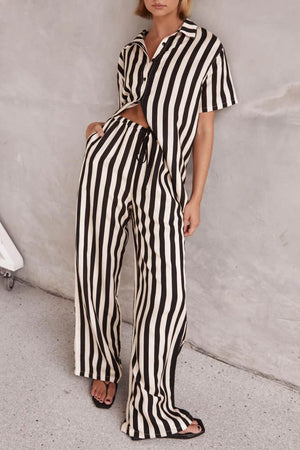 White and black vertical stripe lounge set with cutout top and wide leg pants.