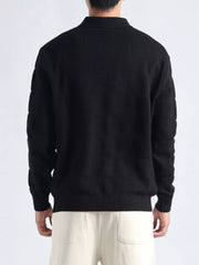 Men's black knit polo top with textured fabric and button accents.