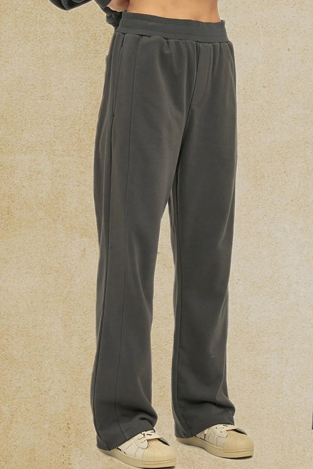 Dark gray seamed lounge trousers with elastic waistband and straight leg