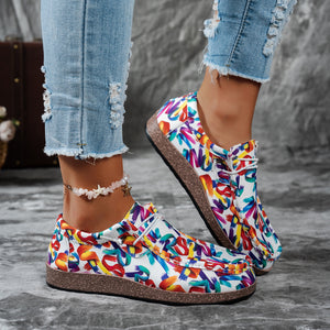Printed casual slip-on loafers with abstract brushstroke pattern in multiple colors.