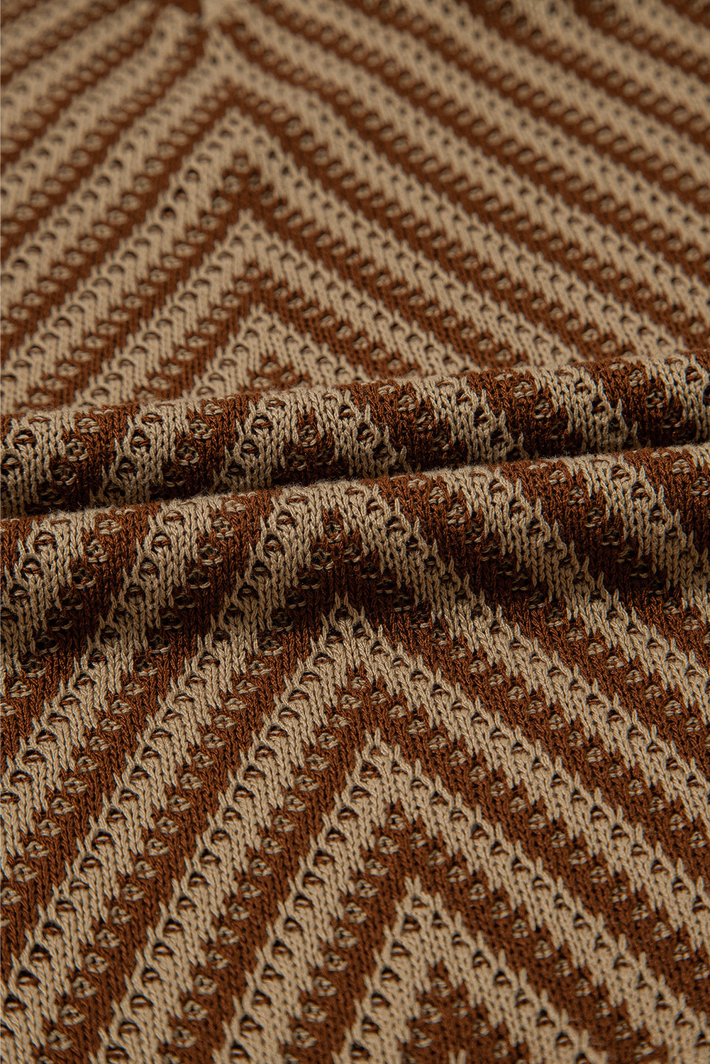 Chevron knit vest in brown and tan with open-knit texture and diagonal stripes.