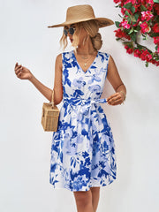 Blue watercolor floral tiered mini dress with V-neck and belted waist.