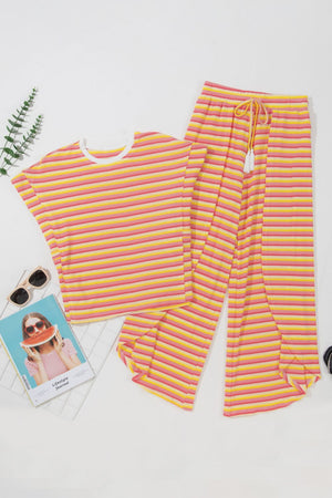 Rainbow stripe culotte jumpsuit in sherbet pink and yellow cotton with drawstring waist and tassel detail.