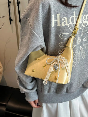 Pastel yellow mini hobo bag with gold accents and pearl & lace charm.