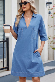 Collared denim mini dress in dark wash with V-neck, short sleeves, and two chest pockets.