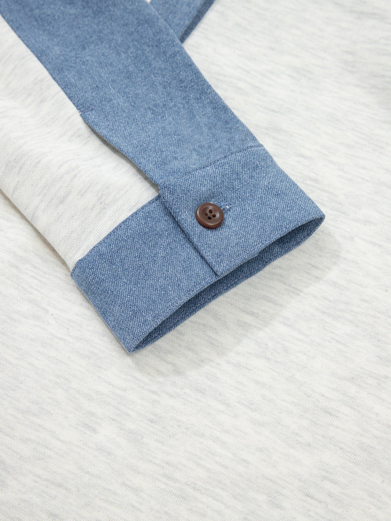 Heathered casual top with denim sleeve detail and button cuff