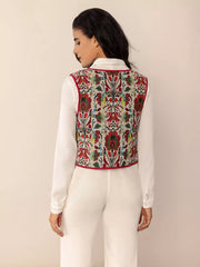 Embroidered tie-front cropped vest coat in deep red with floral pattern and red trim.