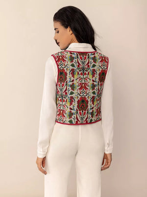 Embroidered tie-front cropped vest coat in deep red with floral pattern and red trim.
