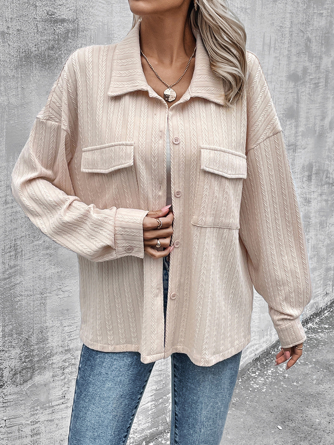 Beige textured overshirt with relaxed fit, button front, and two chest pockets.
