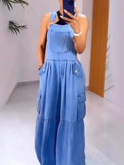 Blue denim wide-leg overalls with bib pocket and cargo pockets, tiered hem.