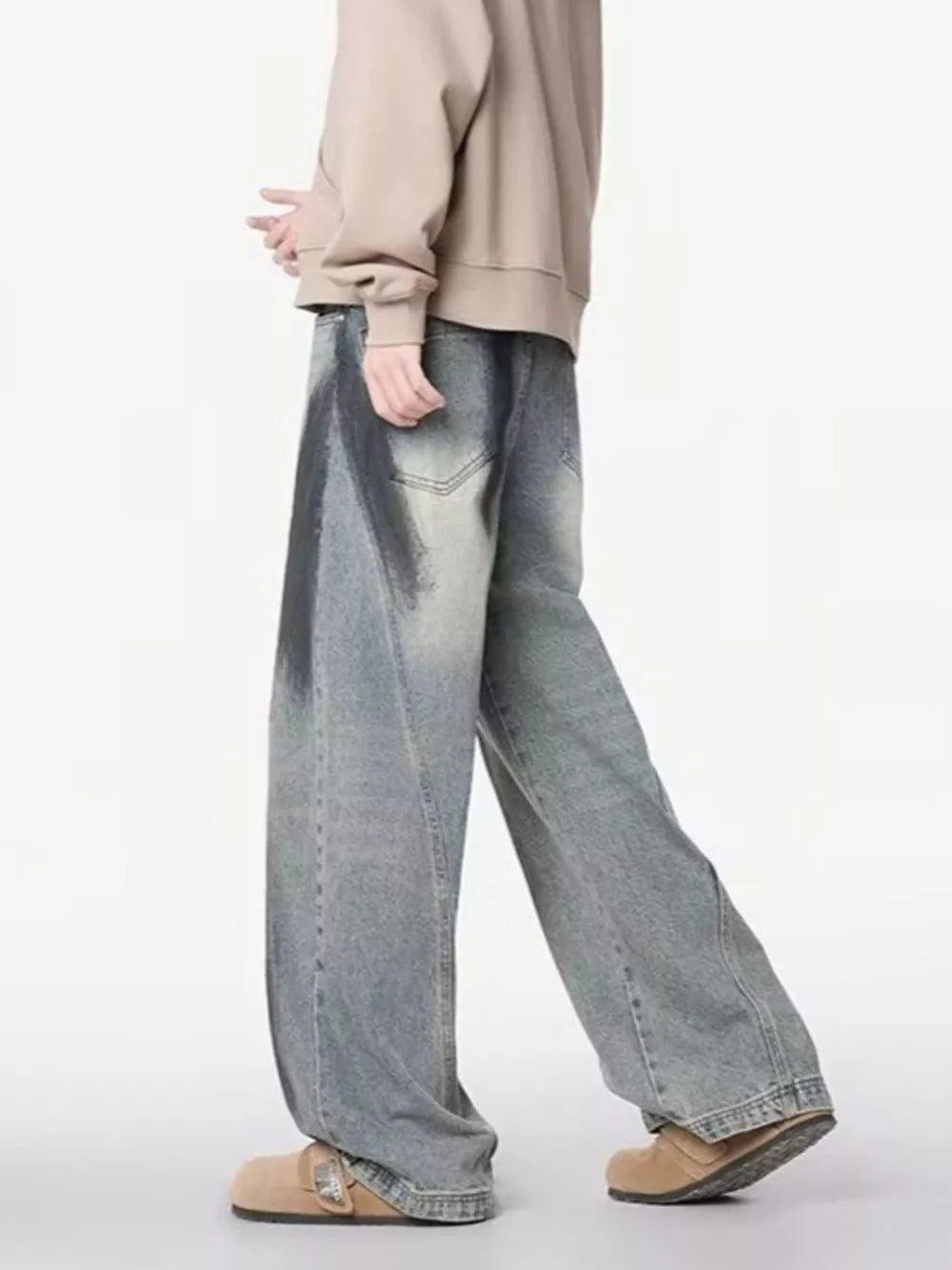 Distressed wide-leg jeans with a belted detail and gradient wash.