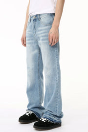 Baggy light wash denim jeans with distressed details and raw hem