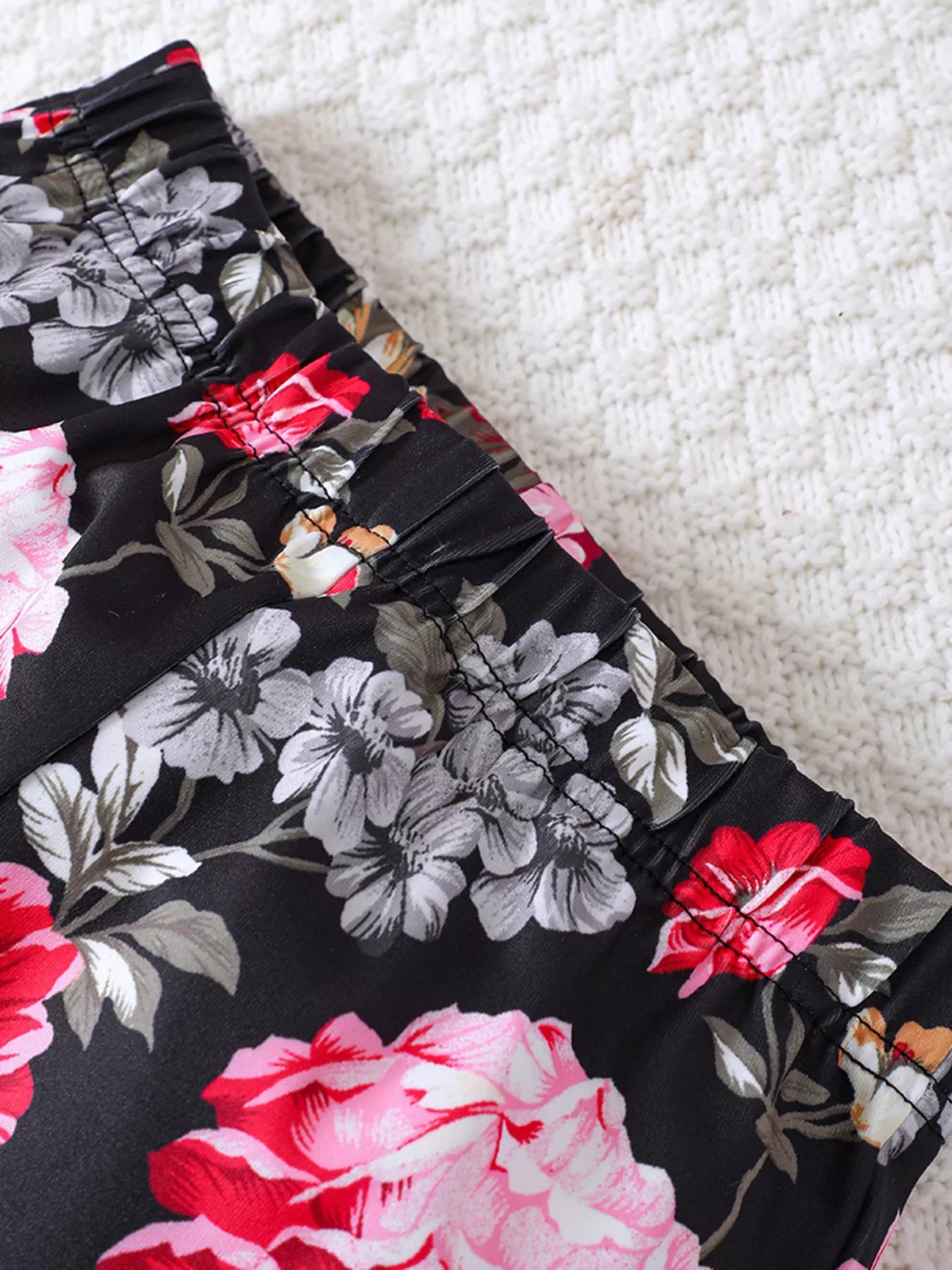 Black floral print flared pants with elastic waistband detail