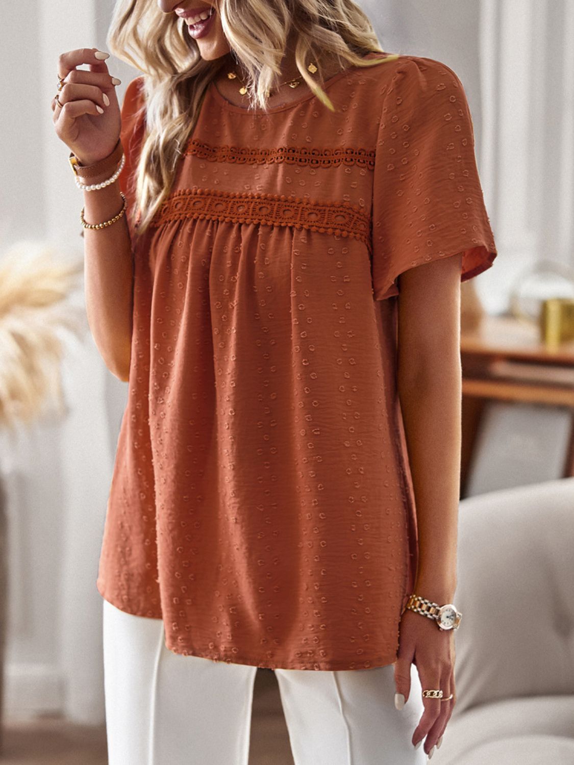 Textured puff sleeve yoke top in terracotta with crochet trim and short sleeves.