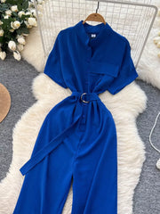 Blue belted wide leg romper with short sleeves and button-down front.