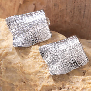 Textured square statement earrings in silver with a unique geometric pattern.