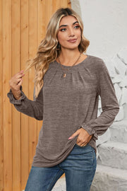 Mocha knit top with pleated yoke and ruffled cuffs, long sleeves, crew neck.